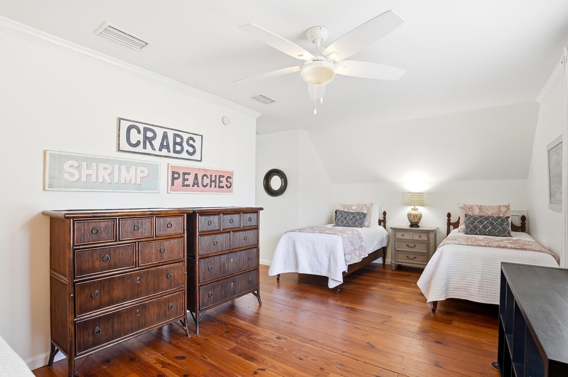 Wide view of the upstairs kingandtwotwin bedroom showing bed placement and dresser storage.