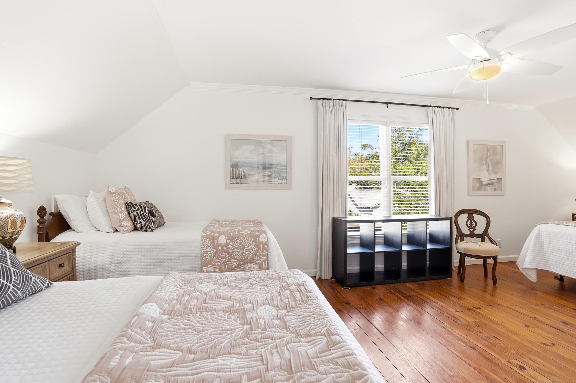 Fullroom view of the upstairs kingandtwotwin bedroom with the king bed on one side and twin beds on the other.