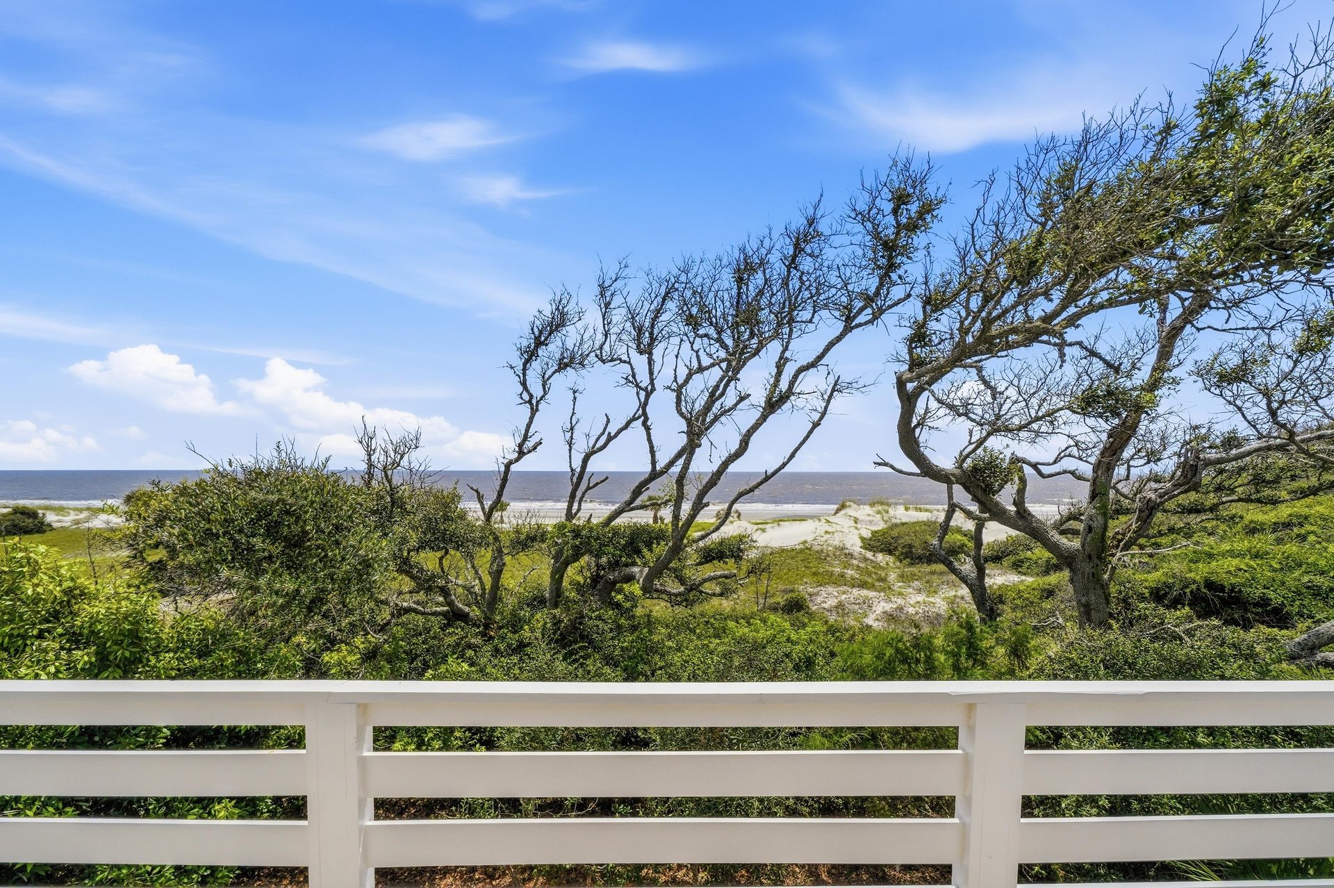 Dunes, maritime trees and the Atlantic fill the view from one of the upstairs queen bedrooms.