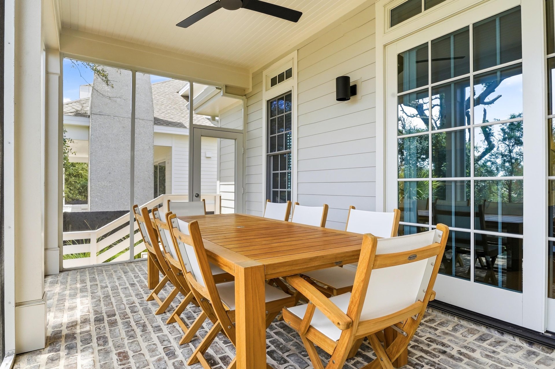The covered dining area sits just outside the kitchen for breakfast, dinner or an evening game.