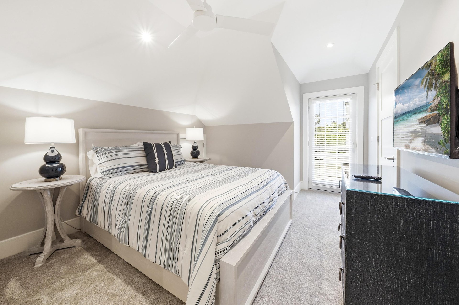This queen room adds a smart TV, nearby full bath and its own balcony over Seaside Retreat.