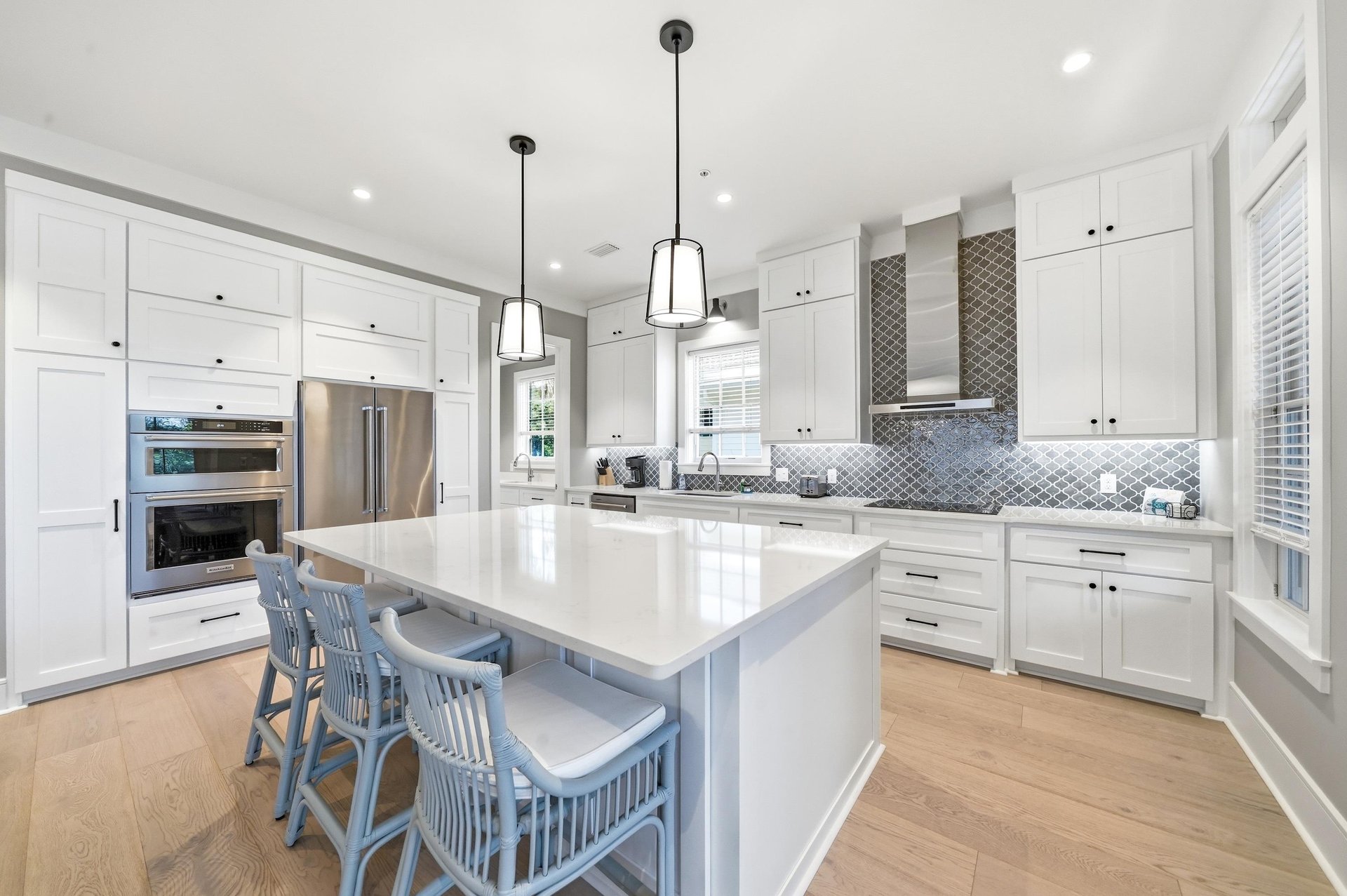 The full kitchen combines quartz counters, abundant cabinetry and a wide island for cooking and conversation.