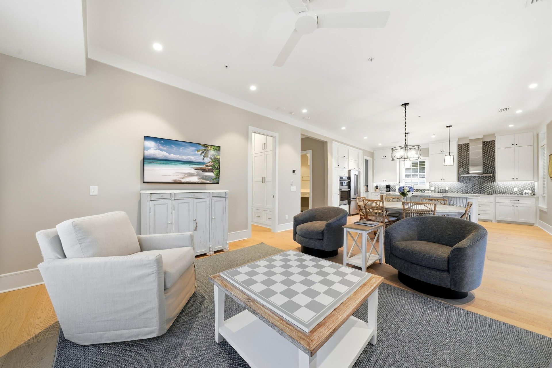 The open layout lets guests move easily between conversation, meals and the screened porch.