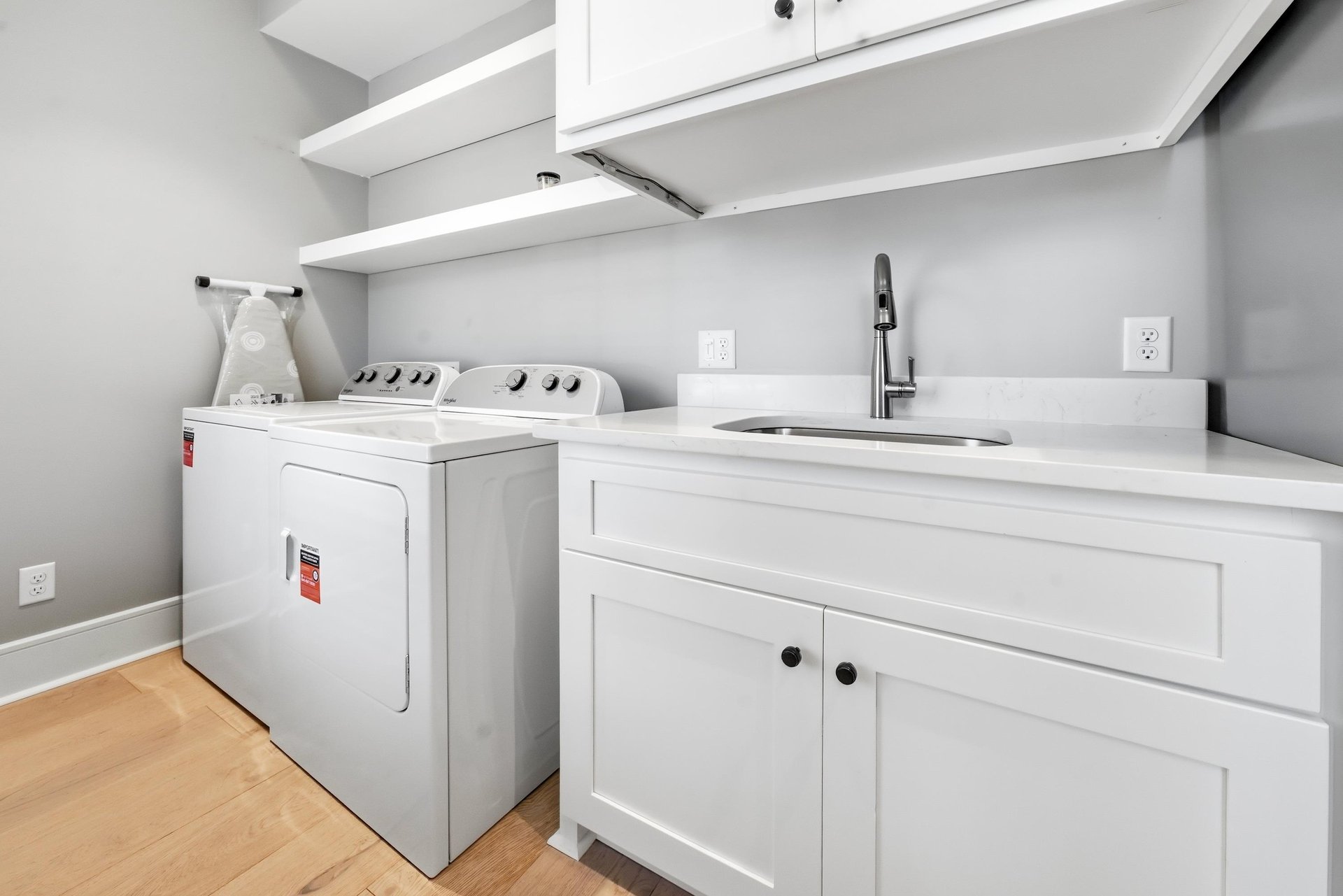 A washer, dryer, utility sink and cabinets make beach towels and everyday cleanup easier.