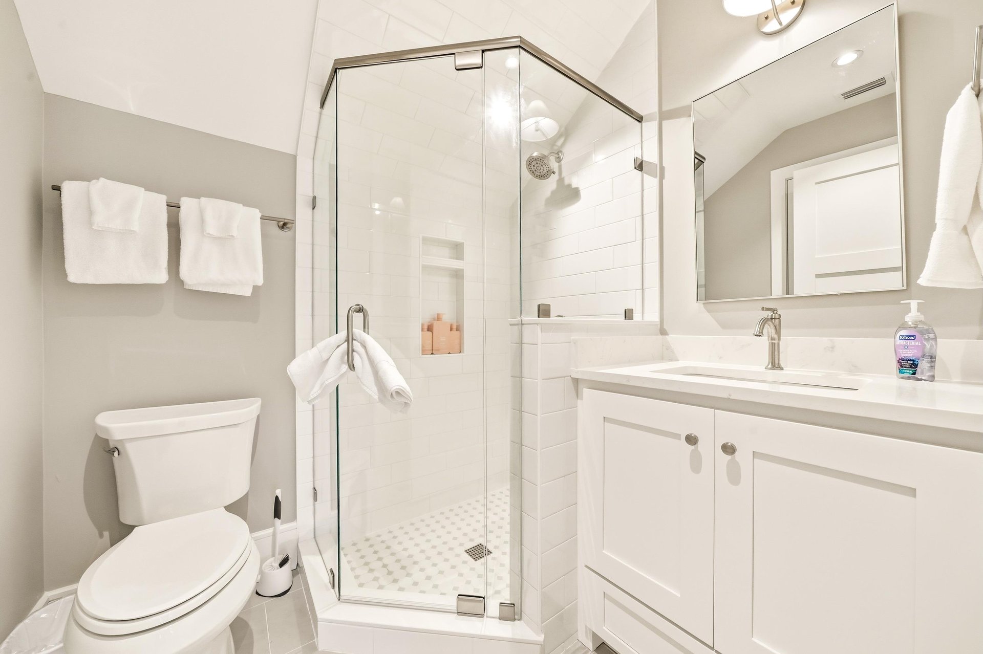This bright bath serves the upperlevel bedrooms with a tiled shower and practical vanity storage.