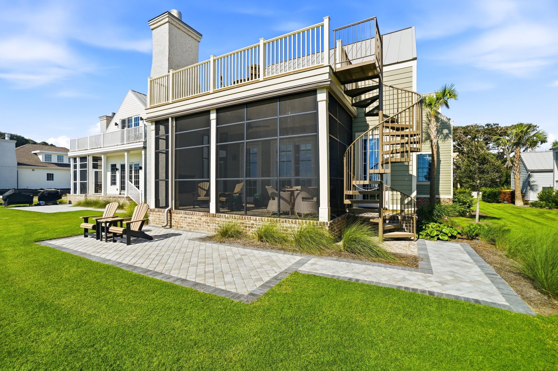 Three outdoor settings face the coast, linked by an exterior spiral stair.