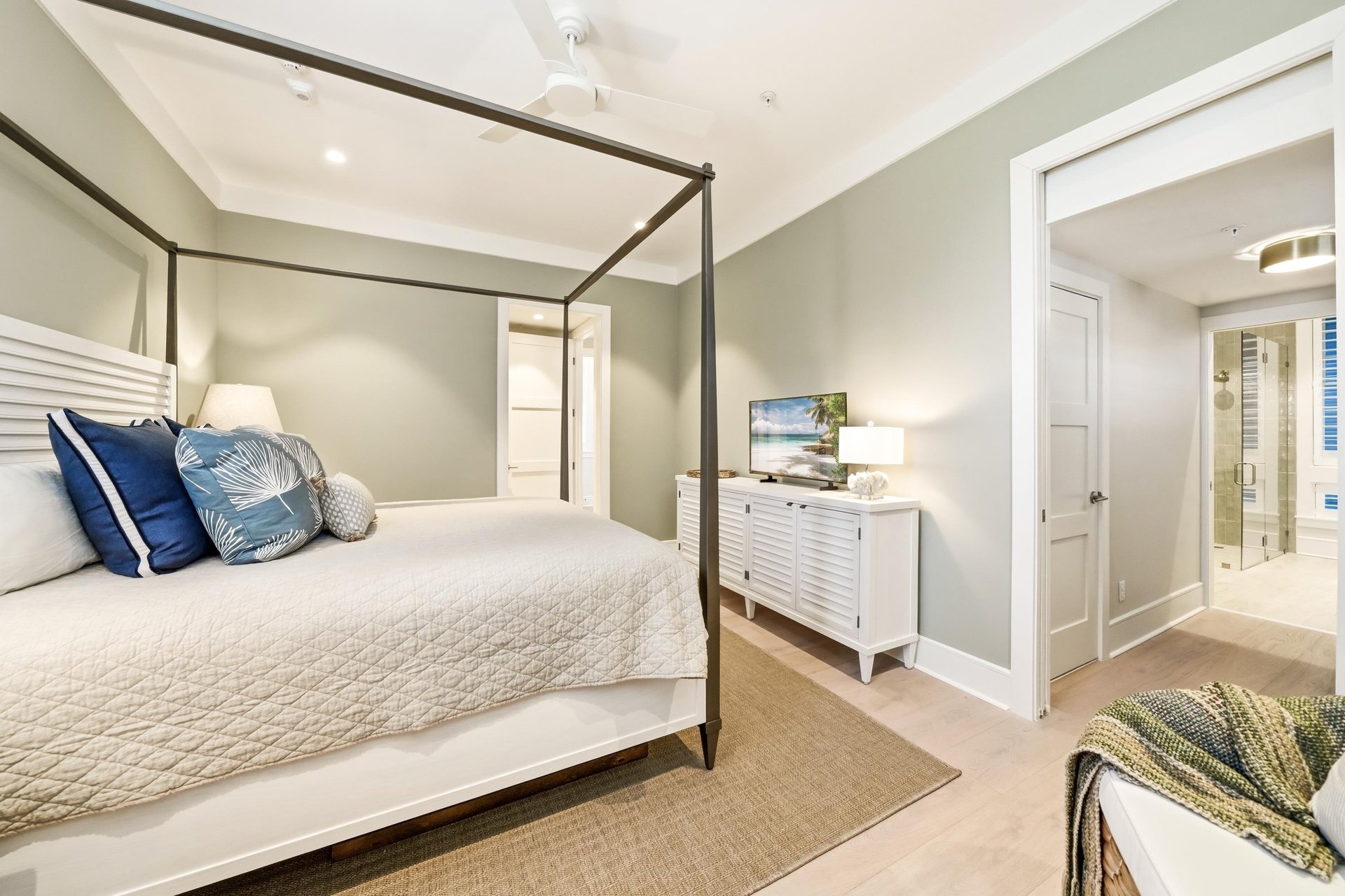A dressing area connects this bedroom to its full bathroom.