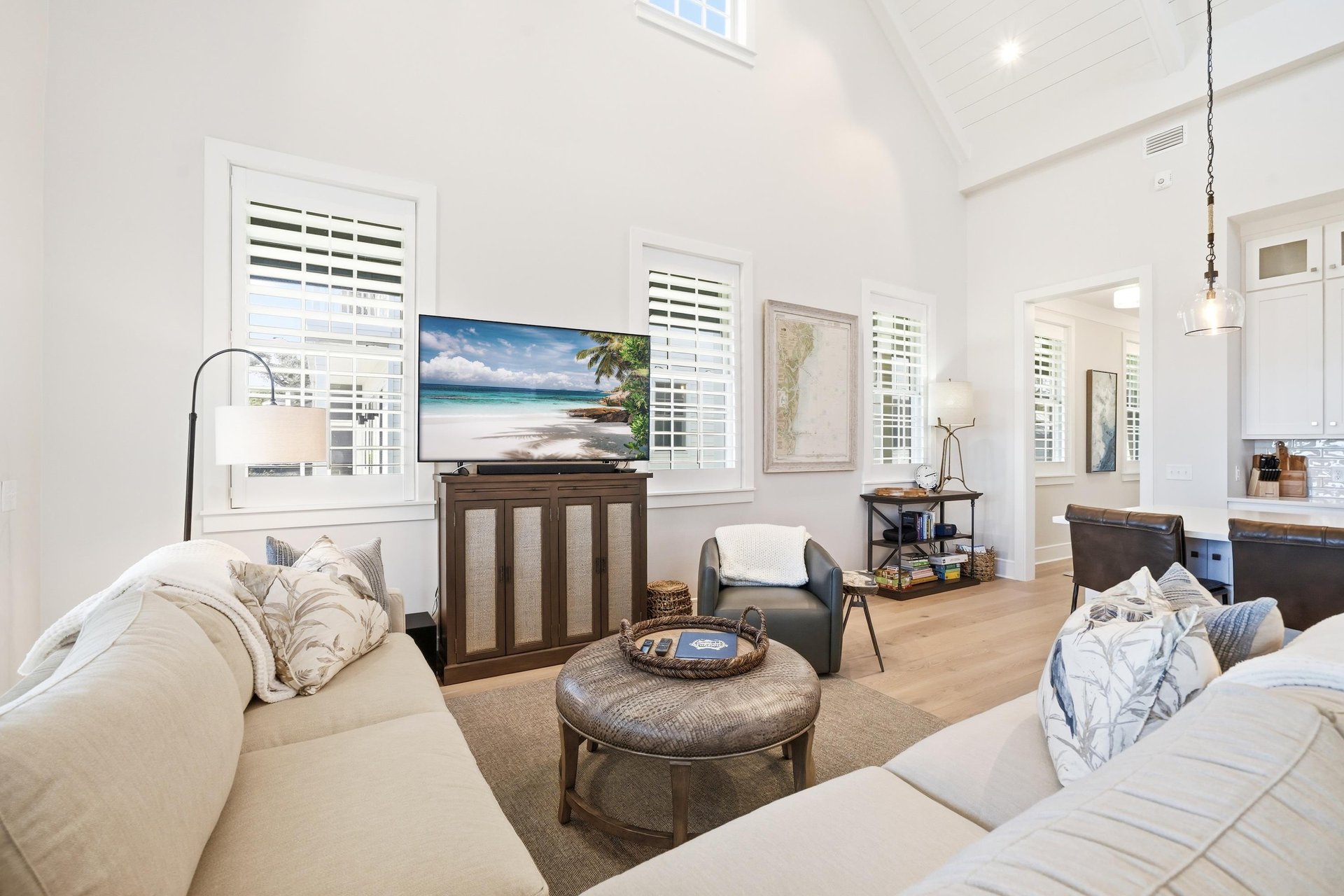An accent chair joins the sectional beside the open kitchen.