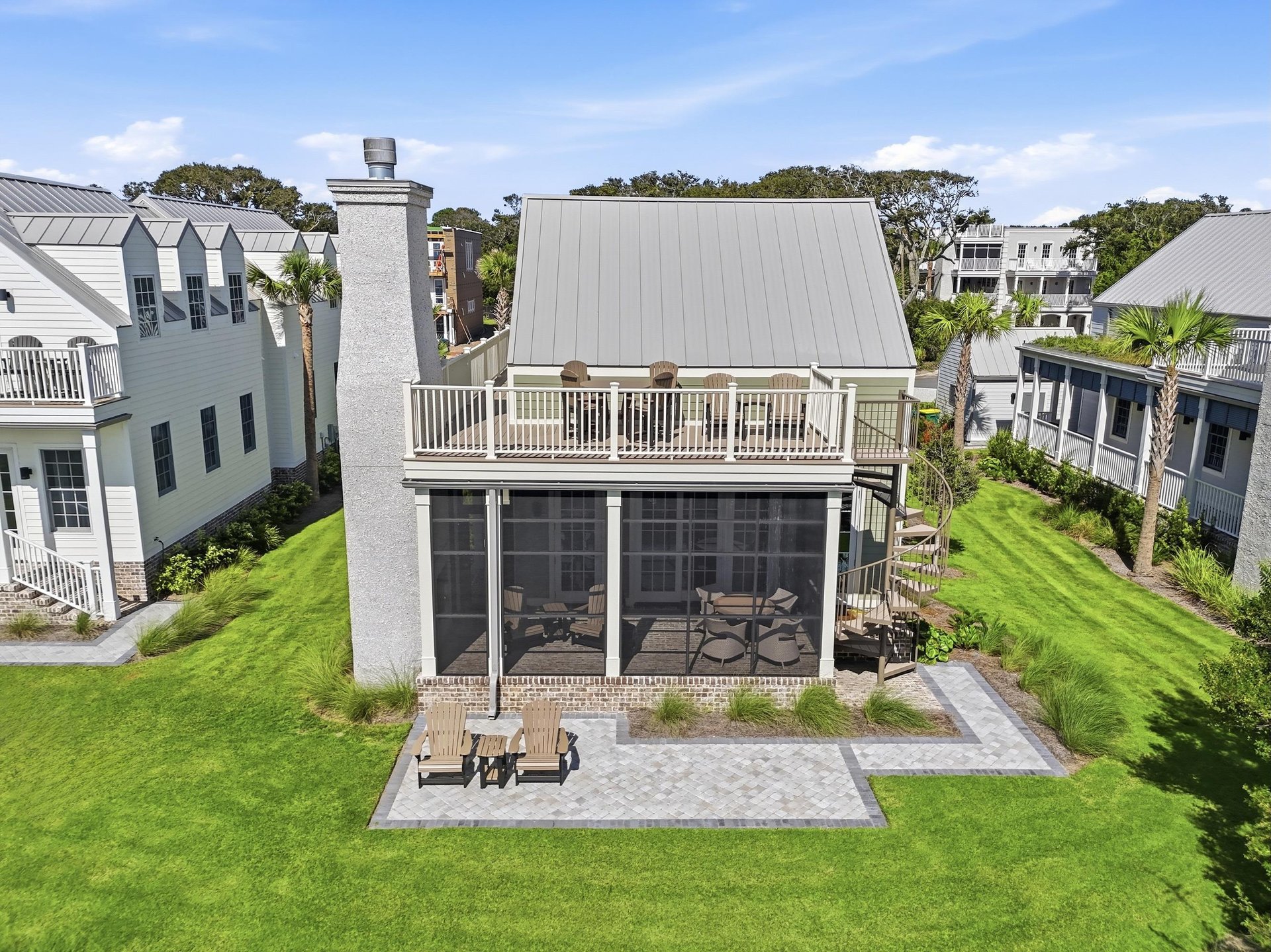 An exterior spiral staircase connects the patio with the upper deck.