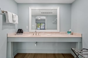 Bathroom vanity counter with large mirror