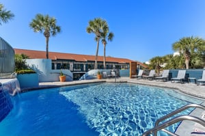 Large 2 tier pool with spacious deck and lounge chairs