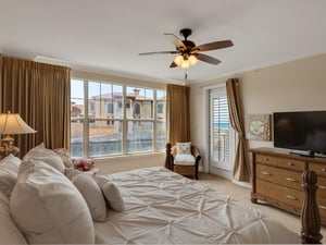 Primary bedroom with view from balcony