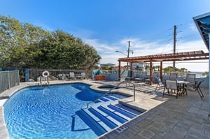 2nd level of the 2 tier pool deck with a hot tub and great Gulf views