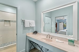 Bathroom vanity counter with larger mirror