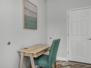 Primary bedroom with desk and chair