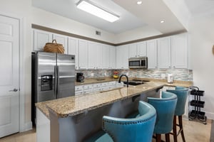 Large modern kitchen with breakfast bar seating for 3