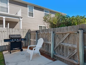 Grilling area inside fenced backyard