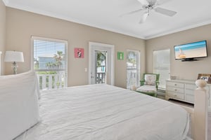 Primary Bedroom on 2nd Floor with TV and Balcony Access