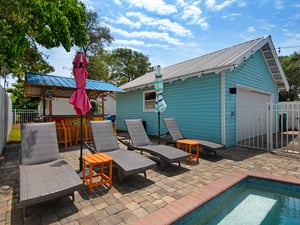 Pool Area with Chaise Lounge Chairs and Umbrellas