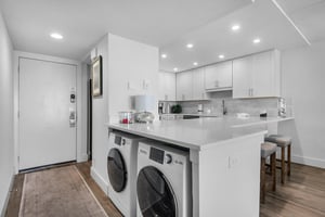 Kitchen with plenty of counter space and convenient laundry center