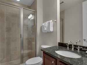 Twin guest room with private bathroom with walk in shower