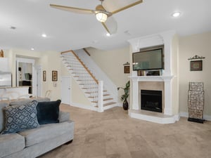 Living area with large TV and decorative fireplace not operational