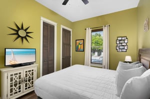 King Bed with Flat Screen TV in Primary Bedroom