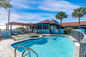 2nd level of the 2 tier pool deck with a hot tub and sun deck with Pergola