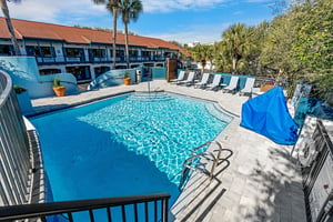 Large 1st tier pool with spacious deck and lounge chairs