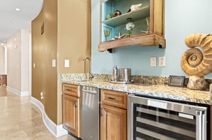 Your stylish wet bar features granite counters, stainless appliances, and coastalinspired shelving perfect for entertaining.
