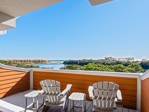 Sip your morning coffee while gazing at stunning coastal views from your private terrace, complete with comfortable seating for relaxing moments.