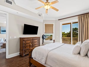 Wake up to stunning views from your primary bedroom balcony. Crisp linens, warm wood furnishings, and coastal breezes create your perfect retreat.