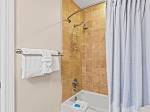 Bathroom 3 Step into your private bathroom featuring elegant stone tile and fresh towels ready for your arrival.