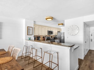 Your modern kitchen features granite counters, stainless appliances, and a breakfast bar perfect for morning coffee or casual dining.