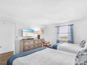 Wake up to coastal comfort in your serene guest bedroom, complete with beachside TV entertainment and elegant oceaninspired decor.