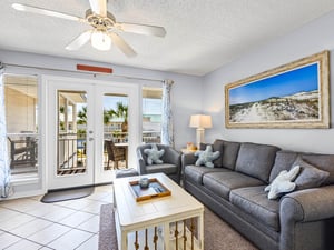 Sink into this cozy living room where beach breezes flow through French doors to the private balcony.