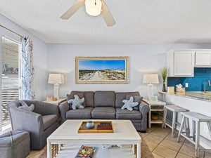Unwind in the bright, airy living space where coastal comfort meets modern style, complete with plush seating and beachinspired touches.