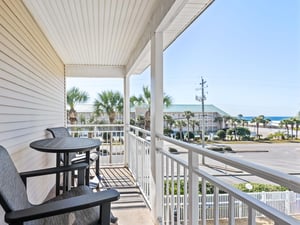 Unwind on the private balcony with gulf glimpses, palm trees, and coastal breezes creating the perfect gulf oasis