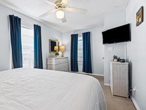 Relax in the peaceful bedroom with crisp linens, gentle ceiling fan breeze, and entertainment at your fingertips.