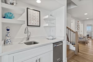 Your sleek wet bar features stainless steel ice maker and modern fixtures for effortless entertaining.