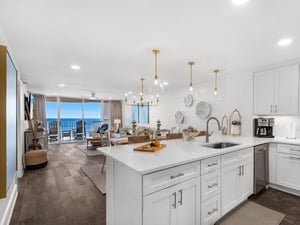Your sleek kitchen island offers stunning ocean views while you prepare meals in this modern coastal paradise.