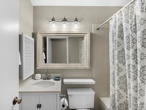 Your private bathroom features a relaxing soaking tub, elegant vanity, and charming coastalinspired decor for your comfort.