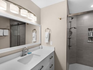 Step into your modern bathroom with sleek finishes, spalike lighting, and a spacious walkin shower for your ultimate comfort.