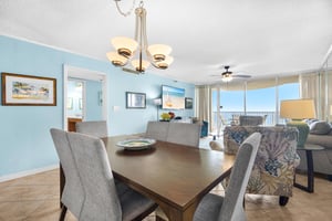 Gather around this elegant dining table where ocean views through floortoceiling windows create the perfect backdrop for your memorable meals together.