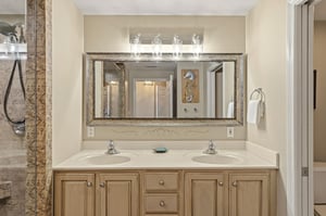 Bathroom 1 with dual sinks and elegant stone finishes for a perfect start to your vacation day.
