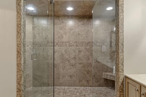Bathroom1 features spalike shower sanctuary with luxurious stone tiles and elegant glass enclosure.