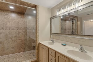 Bathroom 1 with dual sinks, granite counters, and spacious walkin shower with beautiful stone tile work awaits your relaxing retreat.
