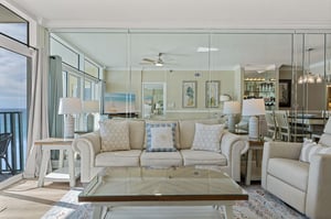 Relax in your bright coastal living room with sleeper sofa, ocean views through floortoceiling windows.
