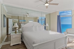 Bedroom 1 with stunning views, where crisp white linens meet coastal breezes through floortoceiling windows.