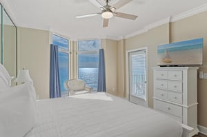 Bedroom 1 where morning light dances across calm waters through floortoceiling windows.